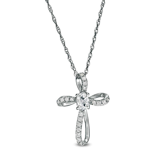 Oval White Topaz and 0.1 CT. T.W. Natural Diamond Pinwheel Cross Pendant in 10K White Gold